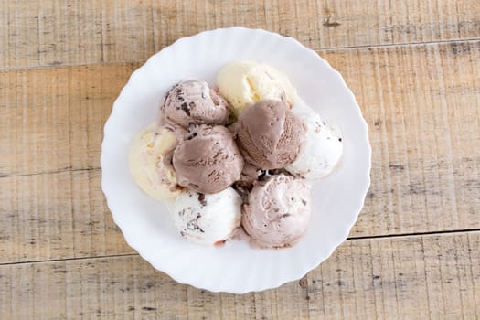 Scoops of chocolate ice cream in the white plate
