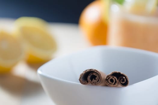 Pair of cinnamon sticks in a white bowl