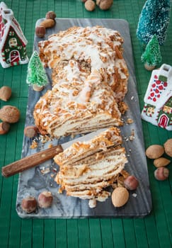 Homemade nut braid with various nuts and Christmas decorations