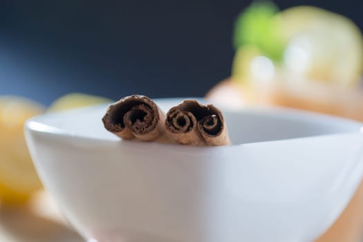 Pair of cinnamon sticks in a white bowl