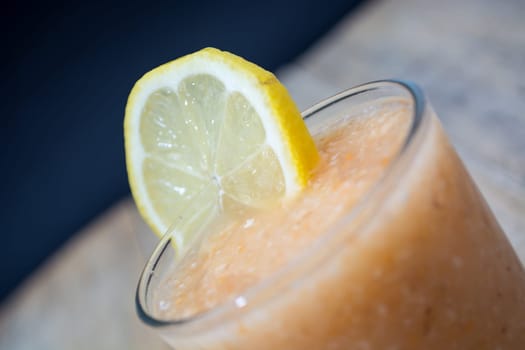 Fresh lemonade with ginger decorated with  lemon on the dark background