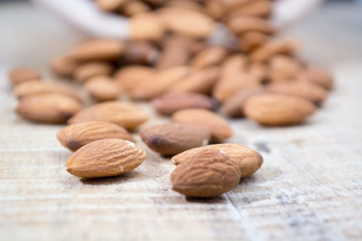 Spilled almonds out of the bowl on the table