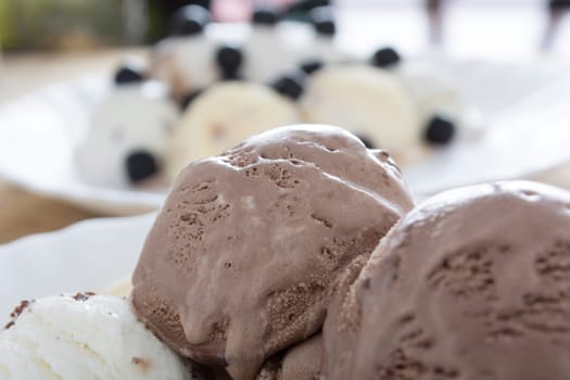 Scoops of chocolate ice cream in the white plate