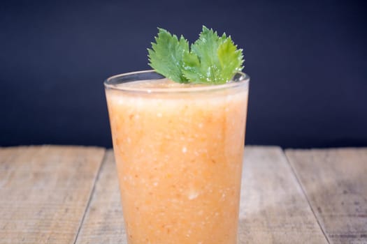Fresh lemonade with ginger decorated with green celery leaves