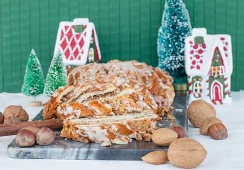 Homemade nut braid with various nuts and Christmas decorations