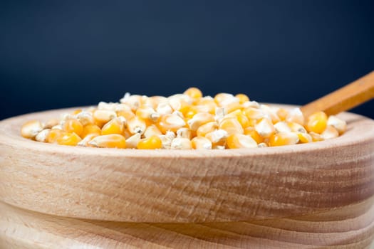 Corn seed in the wooden bowl with the wooden spoon