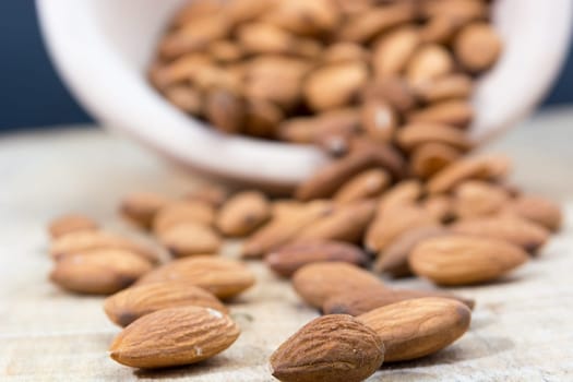 Spilled almonds out of the bowl on the table