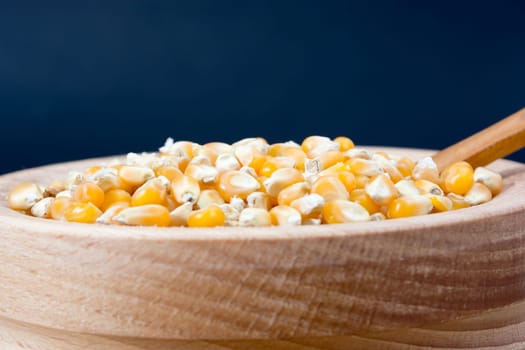 Corn seed in the wooden bowl with the wooden spoon