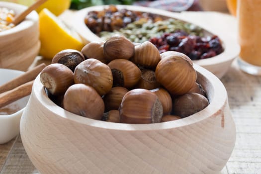 Hazelnuts  in wooden bowl ready to be cracked and eaten