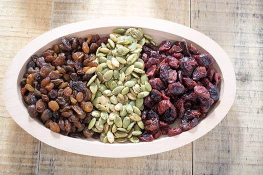 Dry fruit with pumpkin seed in the wooden bowl