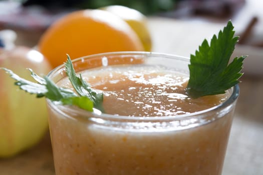 Fresh lemonade with ginger served on a table full with other fruits and cinnamon