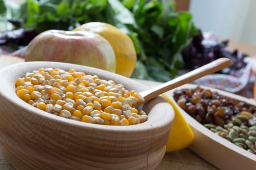 Corn seed in the wooden bowl with the wooden spoon