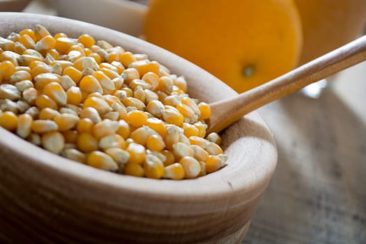 Corn seed in the wooden bowl with the wooden spoon