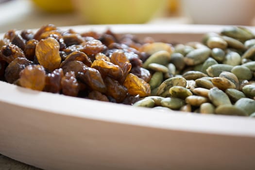 Dry fruit with pumpkin seed in the wooden bowl