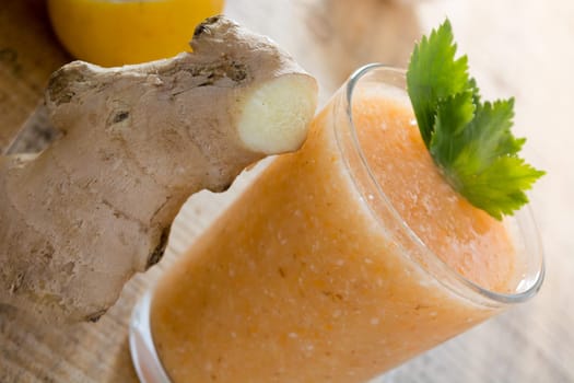 Fresh lemonade with ginger served on a table full with other fruits and cinnamon