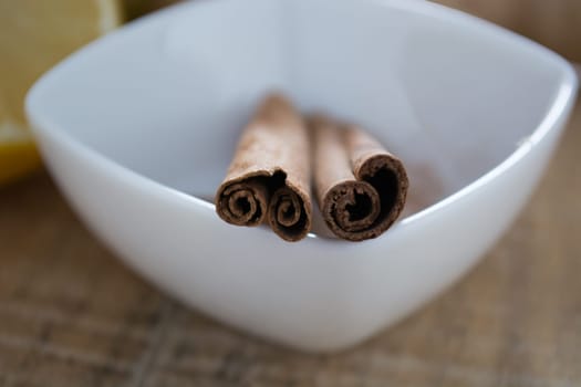 Pair of cinnamon sticks in a white bowl