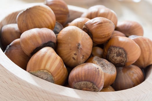 Hazelnuts  in wooden bowl ready to be cracked and eaten
