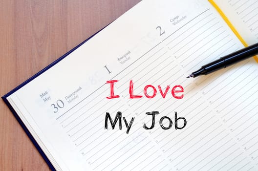 I love my job text concept write on notebook