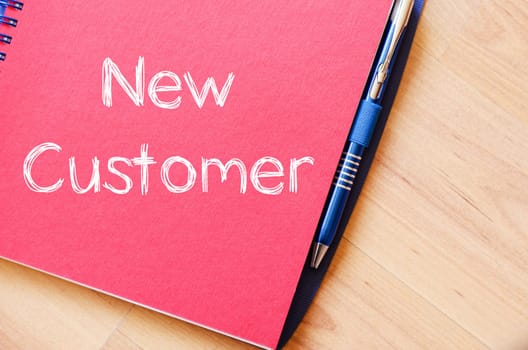 New customer text concept write on notebook
