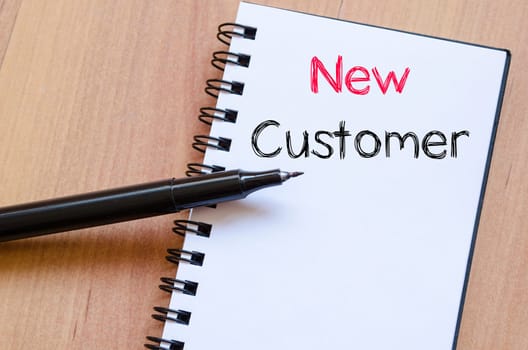 New customer text concept write on notebook