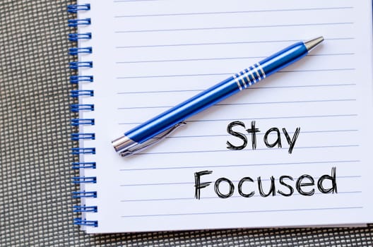 Stay focused text concept write on notebook