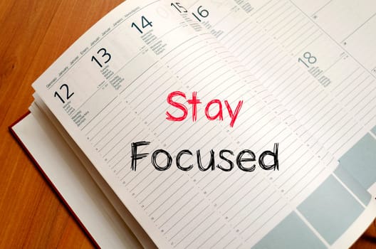 Stay focused text concept write on notebook