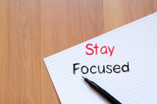 Stay focused text concept write on notebook