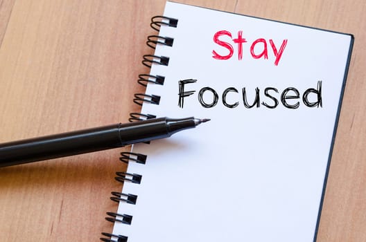 Stay focused text concept write on notebook