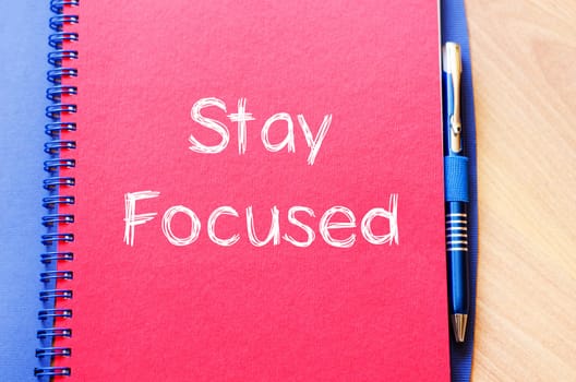 Stay focused text concept write on notebook