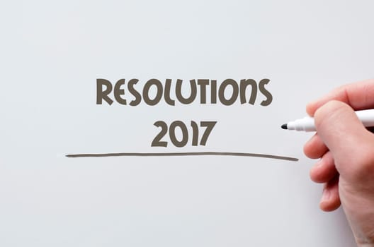 Human hand writing resolutions 2017 on whiteboard