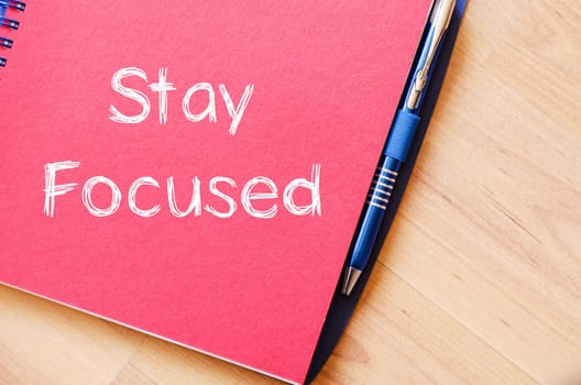 Stay focused text concept write on notebook