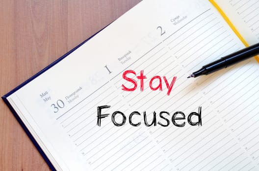 Stay focused text concept write on notebook