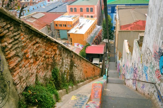 VALPARAISO, CHILE - MAY 28: The funicular railway climbs past lively grafitti above brightly-colored houses in Valparaiso, Chile on May 28, 2014
