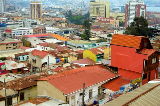VALPARAISO, CHILE - MAY 28: The bright colors of the old town shine above the modern skyscrapers in Valparaiso, Chile on May 28, 2014