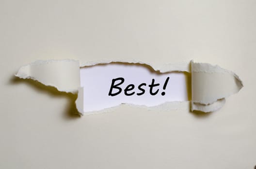 The word best appearing behind torn paper