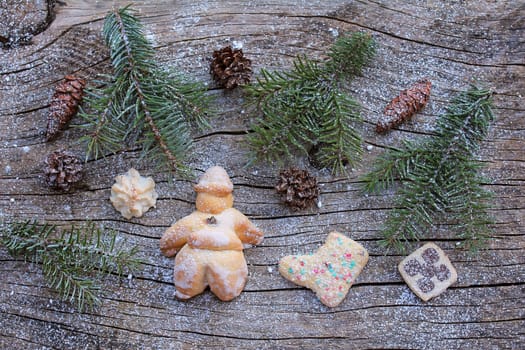 A Santa Claus and cookies made of dough. Christmas decoration on wooden background