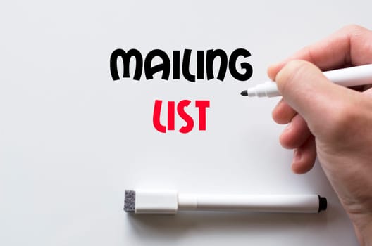 Human hand writing mailing list on whiteboard