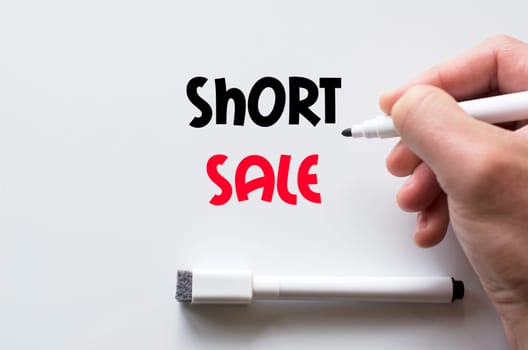 Human hand writing short sale on whiteboard