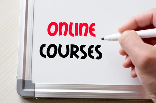 Human hand writing online courses on whiteboard
