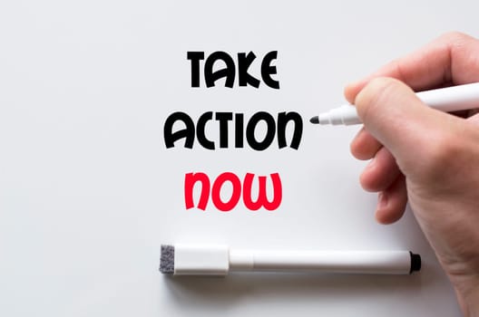 Human hand writing take action now on whiteboard