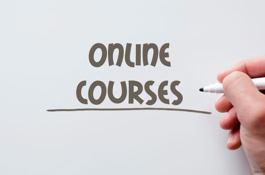 Human hand writing online courses on whiteboard