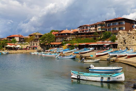 Nesebar, Bulgaria, September 06, 2013: Fishing boats at the pier in the harbor of the old town of Nessebar, Bulgaria. Sunny summer day. Nesebar is an ancient town on the Bulgarian Black Sea Coast.