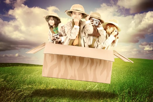 Children in a cardboard box playing Safari