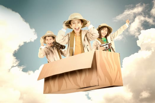 Children in a cardboard box playing Safari
