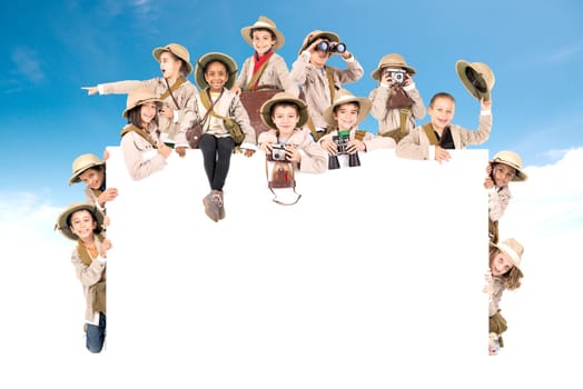 Children's group with safari clothes and gear over a white board
