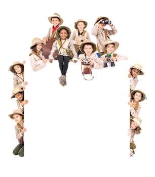 Children's group with safari clothes and gear over a white board