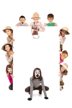 Children's group in safari clothes and animal face-paint over a white board