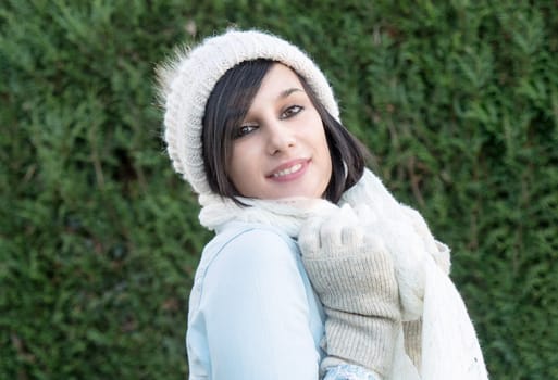 portrait of a pretty young brunette with winter hat, outdoor