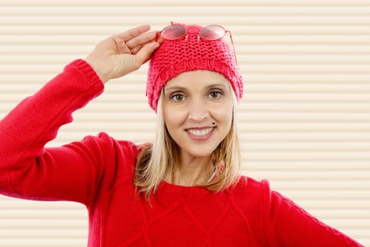 fashion blonde woman with red  sweater and winter hat