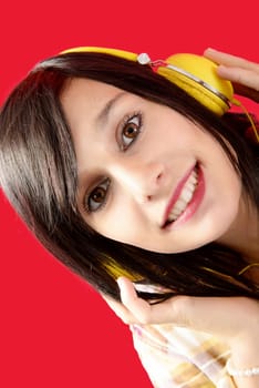 Beautiful brunette woman with headphones on red background